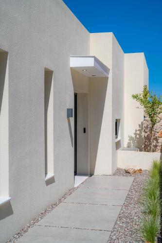 a modern house with white walls and a walkway at Nimbus Villas in Kalamitsi