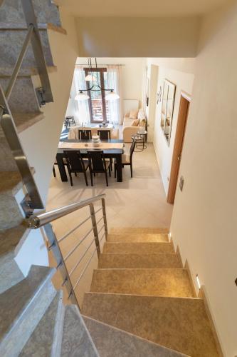 a staircase leading to a living room and dining room at Villa Callisti in Pylos