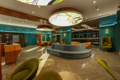 a lobby with a blue couch and chairs at Palm Springs Resort in Nashik