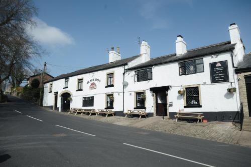 a white building on the side of a street at Black Dog Inn in Bolton