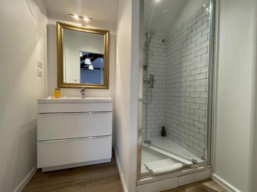 a bathroom with a shower and a sink and a mirror at Domaine De Bonaveau - Privatisation Spa et Piscine in Barcelonne