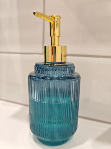 a blue glass bottle with a gold faucet at SEASIDE apartment, sleeps 3 persons in Liepāja