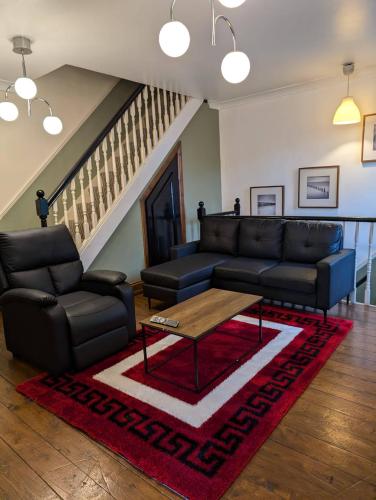 a living room with a couch and a coffee table at 3B-10min City Airport Parking No Parties allowed in London