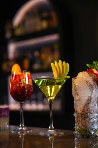 two cocktails are sitting on a table at Palm Springs Resort in Nashik