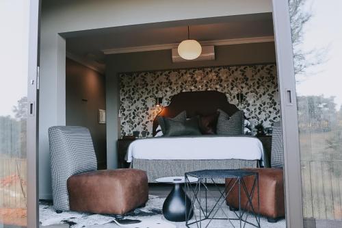 a bedroom with a bed and a table at The Rasmus in Pretoria