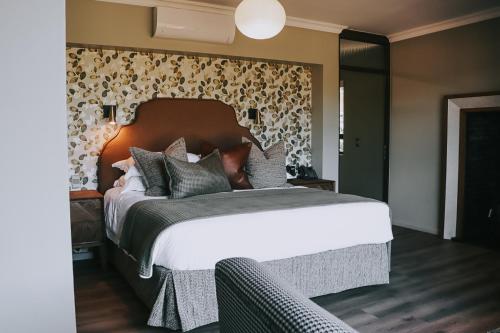 a bedroom with a large bed with a headboard at The Rasmus in Pretoria