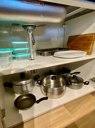 a kitchen with three pots and pans on a stove at Praia de Piratininga Apartamento Vista Para o Mar in Niterói