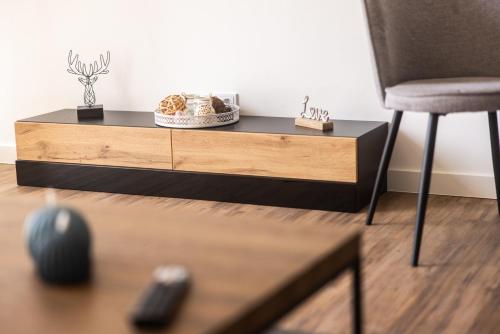 a coffee table in a living room with a chair at Havelpension in Rathenow