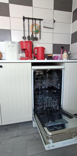 an oven with its door open in a kitchen at Cozy Gardens Apartments in Prague in Prague