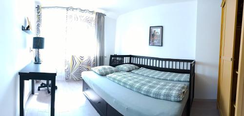 a bedroom with a bed and a table and a window at Cozy Gardens Apartments in Prague in Prague
