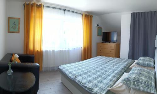 a bedroom with a bed and a tv and a window at Cozy Gardens Apartments in Prague in Prague