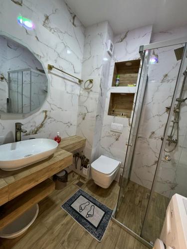 a bathroom with a sink toilet and a shower at Moonlight Apart-Hotel Batumi in Batumi