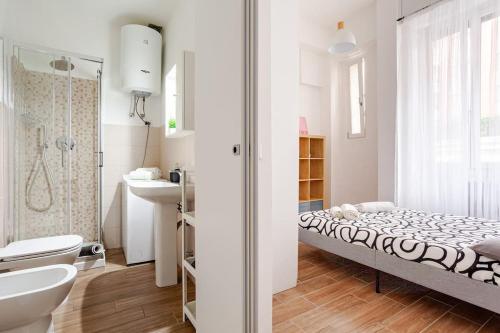 a white bathroom with a bed and a sink at San Siro-A 10 min a piedi da San Siro con WIFI in Milan