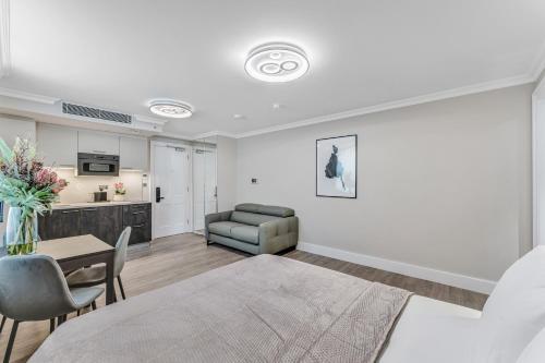 a living room with a couch and a table at Cleveland Residences Bloomsbury in London