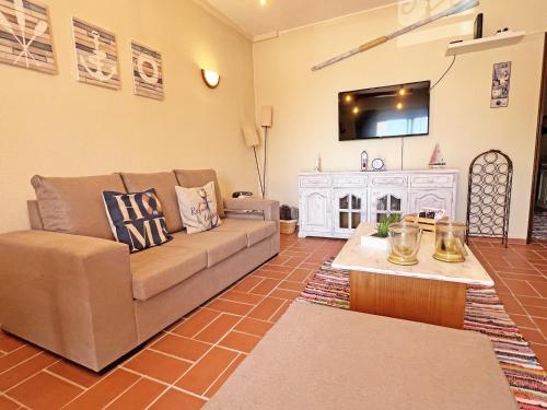 a living room with a couch and a table at A Minha Casinha - Marim Olhão By Junto ao Mar in Moncarapacho