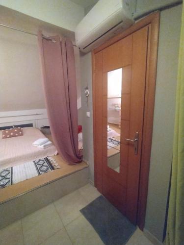 a room with a door and a bedroom with a bed at Vasiliki's home in Kalyves Poligirou