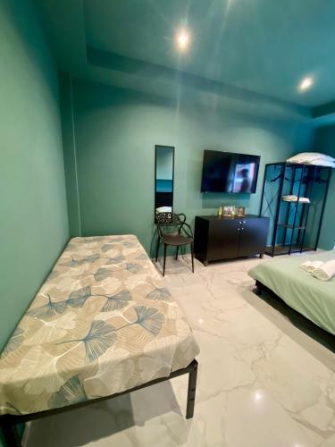 a bedroom with a bed and a tv in it at Vale House Apartment near Rho Fair in Baranzate