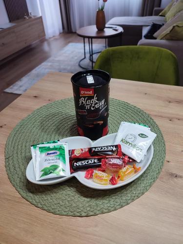 a plate of food with a cup of coffee and snacks at Stan na dan Paradiso in Lukavica