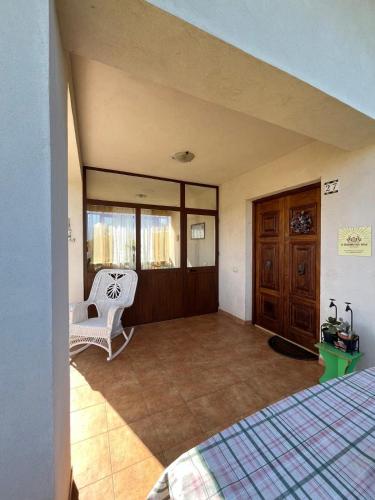 a bedroom with a bed and a chair in a room at Il Giardino del Sole in Villagrazia