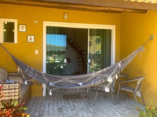 a hammock on the porch of a house at Imbassai Summer Flats Village in Imbassai