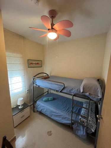 a bedroom with a bunk bed and a ceiling fan at SELA HOME y Garaje, Algemesi Home in Algemesí