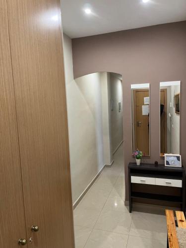 a hallway with a bathroom with two mirrors at SELA HOME y Garaje, Algemesi Home in Algemesí
