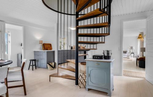 a living room with a spiral staircase in a room at 3 Bedroom Awesome Home In Otterup in Otterup