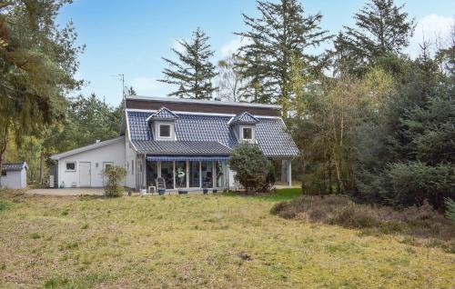 a white house with a blue roof at Amazing Home In Höllviken With Wifi in Höllviken