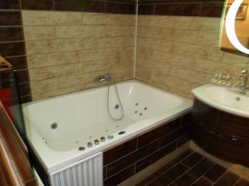 a bath tub and a sink in a bathroom at Kornilios Palace in Anchialos