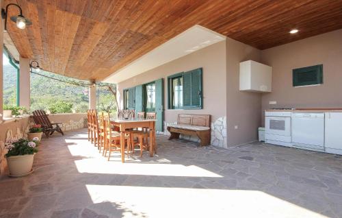 a kitchen and dining room with a table and chairs at Lovely Home In Avella in Avella