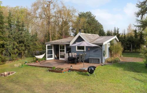 a small blue house with a porch and a deck at Beautiful Home In Slagelse With Wifi in Slagelse