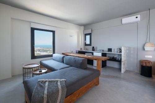 a living room with a couch and a table at IfestAu.4 Suites in Fira