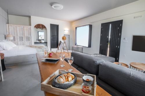 a living room with a couch and a table at IfestAu.4 Suites in Fira