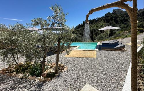 a resort with a pool and an umbrella and trees at Evoikon in Liyiá