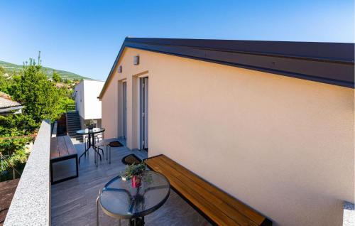 a balcony with a bench and a table on a building at Lovely Apartment In Gornji Karin in Gornji Karin