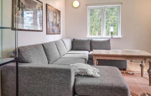 a living room with a couch and a table at Lovely Home In Rimforsa With Lake View in Rimforsa