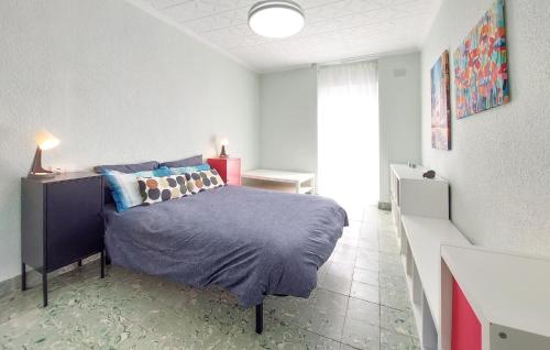 a bedroom with a bed with a blue comforter at Gorgeous Home In Llaurí With Wifi in Llaurí