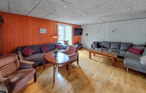 a living room with a couch and a table at Cozy Apartment In Åsljunga With Sauna in Åsljunga