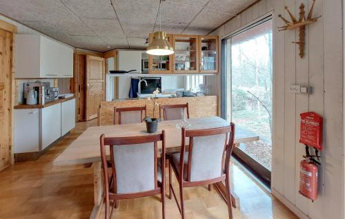 a kitchen and dining room with a table and chairs at Cozy Apartment In Åsljunga With Sauna in Åsljunga