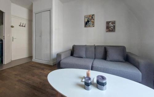 a living room with a couch and a table at Stunning Apartment In Saint-Malo in Saint Malo