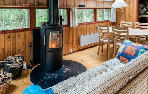 a fireplace in a living room with a couch and a table at 2 Bedroom Gorgeous Home In Ebeltoft in Ebeltoft