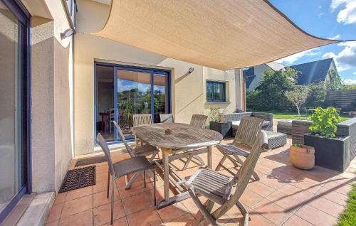 Un patio con una mesa y sillas en un patio. en Nice Home In Montreuil-Sous-Pérouse, en Montreuil-sous-Pérouse