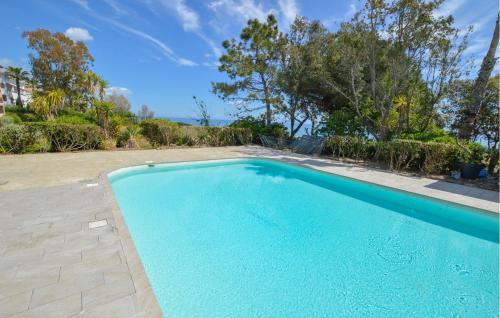 une piscine vide dans une cour arborée dans l'établissement Gorgeous Apartment In Moriani, à Moriani-Plage