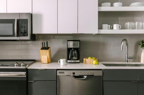 a kitchen with white cabinets and a stainless steel appliance at Sonder by Marriott Bonvoy Village 21 Apartments Hillsboro Village in Nashville