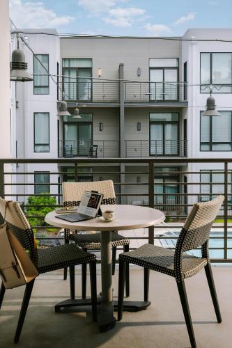 a table and chairs on a balcony with a laptop on it at Sonder by Marriott Bonvoy Village 21 Apartments Hillsboro Village in Nashville