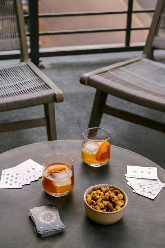 a table with two glasses and a bowl of nuts at Sonder by Marriott Bonvoy Village 21 Apartments Hillsboro Village in Nashville