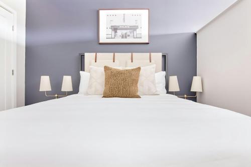 a bedroom with a large white bed with a pillow at Sonder by Marriott Bonvoy Belcourt Apartments Hillsboro Village in Nashville