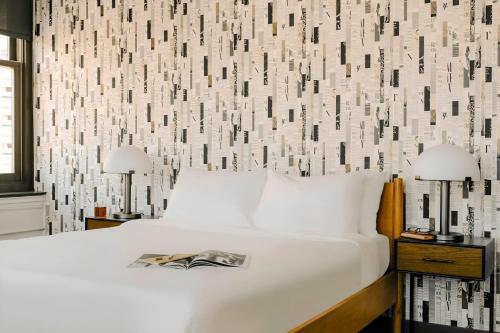 a bedroom with a bed and a wall with a pattern at Sonder by Marriott Bonvoy Gabriel Richard Apartments Downtown in Detroit