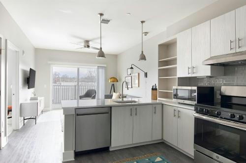 a kitchen with white cabinets and a large window at Sonder by Marriott Bonvoy Belcourt Apartments Hillsboro Village in Nashville