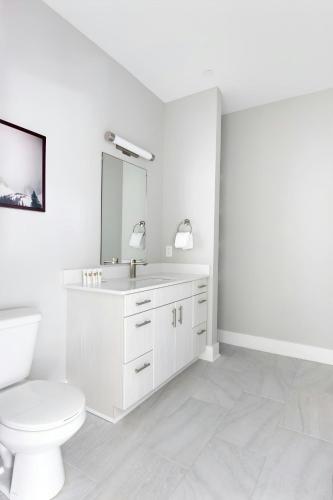 a white bathroom with a toilet and a sink at Sonder by Marriott Bonvoy Belcourt Apartments Hillsboro Village in Nashville